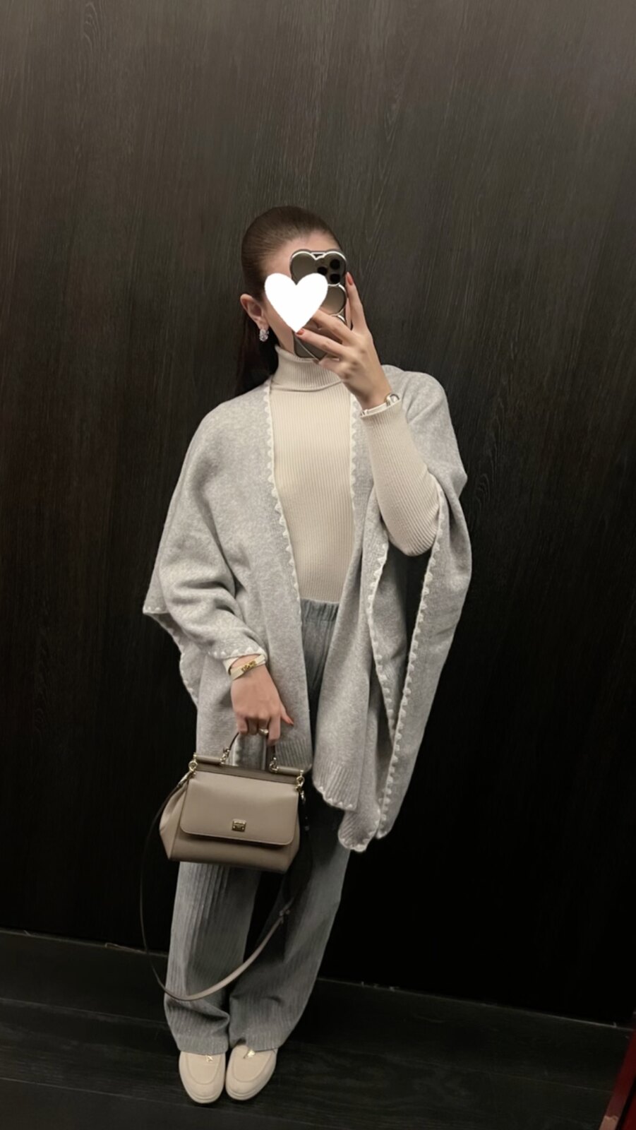 Irina, an off-duty mirror selfie in a grey cashmere cape and loungewear with a taupe top-handle bag