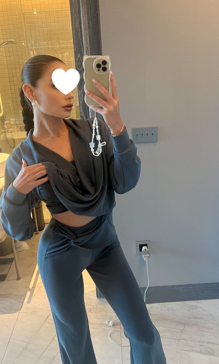 Irina, a candid mirror selfie in a draped grey loungewear set